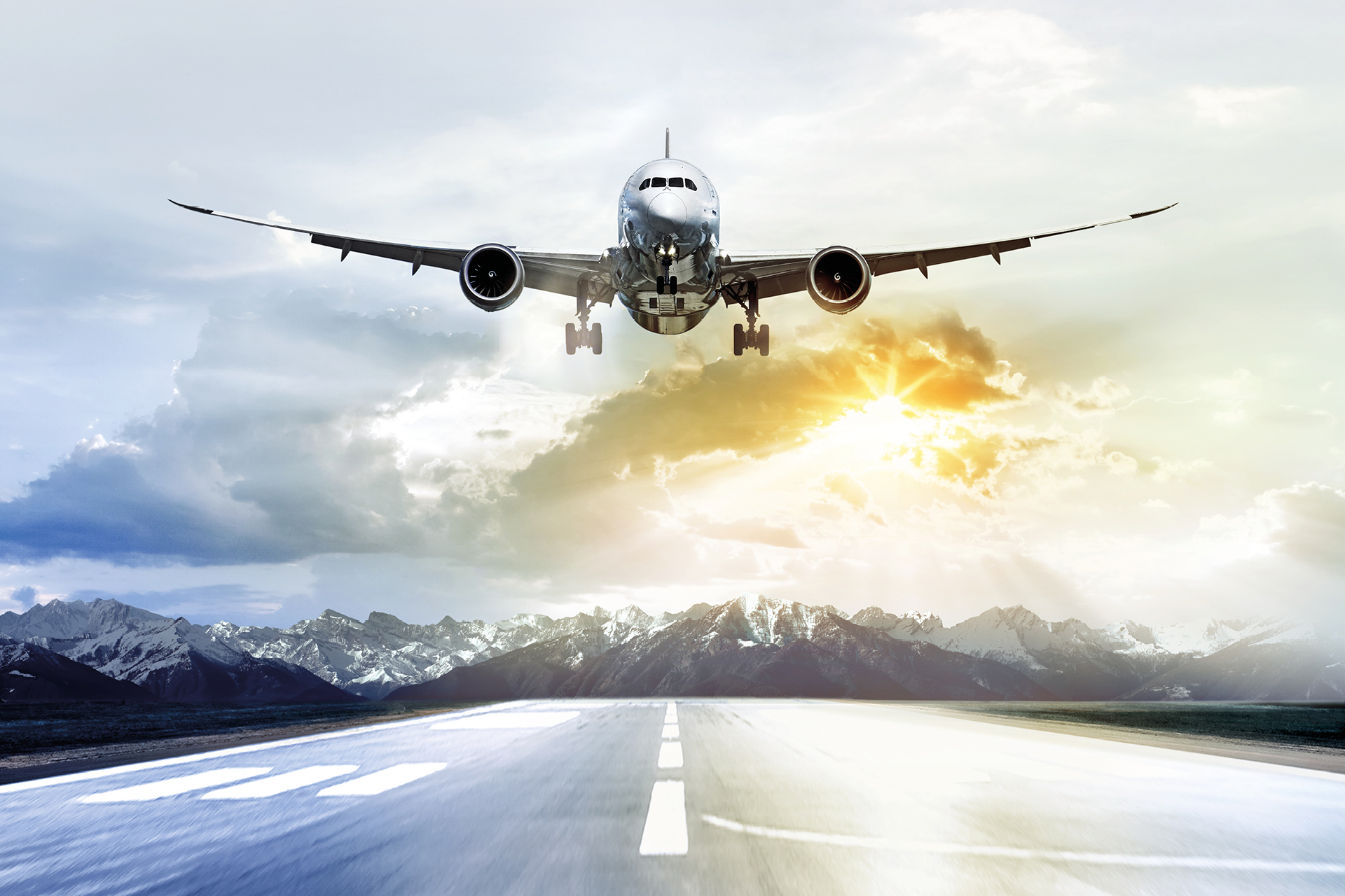 Passenger airplane taking off at sunset